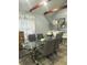 Dining room with modern glass table and chairs, accented by a bright window at 130 Avenue H Se, Winter Haven, FL 33880