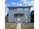Two-story home featuring windows, front door with a Buddha statue and a well-maintained lawn at 130 Avenue H Se, Winter Haven, FL 33880