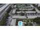 Wide aerial view of a condo complex featuring a pool, tennis courts, and ample parking near a highway at 131 Water Front Way # 220, Altamonte Springs, FL 32701