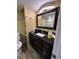 Bathroom featuring a dark wood vanity, granite countertop, and tiled shower at 131 Water Front Way # 220, Altamonte Springs, FL 32701