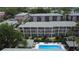 Aerial view of a condo complex, pool, and outdoor seating area surrounded by mature trees at 131 Water Front Way # 220, Altamonte Springs, FL 32701
