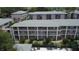 Aerial view of a three-story condo complex with a swimming pool and lounge chairs at 131 Water Front Way # 220, Altamonte Springs, FL 32701