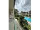 Balcony view of a community pool with lush landscaping and multiple-story condo buildings at 131 Water Front Way # 220, Altamonte Springs, FL 32701