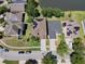 Aerial view of a home with solar panels on the roof, situated near a pond in a residential area at 14963 Braywood Trl, Orlando, FL 32824
