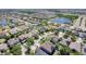 Sweeping aerial view of a neighborhood featuring homes, ponds, and lush greenery at 14963 Braywood Trl, Orlando, FL 32824
