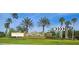 Welcome to Wyndham Lakes Estates! Beautiful community entrance with lush landscaping and palm trees at 14963 Braywood Trl, Orlando, FL 32824