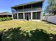 Two story home with a screened in patio, large backyard, and white vinyl privacy fence at 14963 Braywood Trl, Orlando, FL 32824