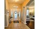 Inviting foyer with tile flooring, decorative columns, and views of the living room, setting a stylish tone at 14963 Braywood Trl, Orlando, FL 32824