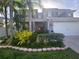 Charming two-story home with well-manicured landscaping and an attached two-car garage at 14963 Braywood Trl, Orlando, FL 32824