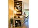Hallway with accent wall with stylish decorations and a breakfast bar creating a warm atmosphere at 14963 Braywood Trl, Orlando, FL 32824