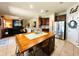 Open concept kitchen with a large island, stainless steel appliances, and hardwood cabinets at 14963 Braywood Trl, Orlando, FL 32824