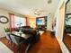 Bright living room with hardwood floors, a large sectional sofa, and stylish decor and dining table at 14963 Braywood Trl, Orlando, FL 32824