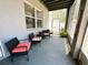 Relaxing covered patio featuring comfortable seating, ideal for enjoying the outdoors in a serene setting at 14963 Braywood Trl, Orlando, FL 32824