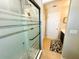 Modern bathroom shower with sleek glass door and tile, adjacent to vanity and patterned floor mat at 14963 Braywood Trl, Orlando, FL 32824