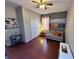 Small sitting room with gray walls, love seat, hardwood floors, and an art piece at 14963 Braywood Trl, Orlando, FL 32824