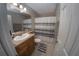 Cozy bathroom with a vanity, mirror, and shower with a gray and white striped curtain at 1695 Lee Rd # E215, Winter Park, FL 32789