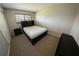 Bedroom with neutral walls, carpeted floors, a dark bed frame, and ample natural light at 1695 Lee Rd # E215, Winter Park, FL 32789