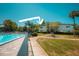 Community pool with lounge chairs surrounded by lush landscaping at 1695 Lee Rd # E215, Winter Park, FL 32789