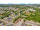 Aerial view showcasing a residential neighborhood with tree-lined streets and a mix of single-Gathering homes and townhouses at 1773 Barton Towne Cir, St Cloud, FL 34769