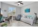 Bright bedroom with daybed, ceiling fan, desk, and recliner offering a comfortable, versatile space at 1773 Barton Towne Cir, St Cloud, FL 34769