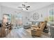Modern living room showcasing wood floors, recessed lighting, and natural light from the sliding glass doors at 1773 Barton Towne Cir, St Cloud, FL 34769