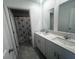 Modern bathroom featuring a double sink vanity with a shower and decorative shower curtain at 1796 Foreman Rd, Eagle Lake, FL 33839