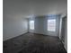 A carpeted bedroom with a window, and access to additional rooms within the home at 1796 Foreman Rd, Eagle Lake, FL 33839