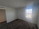 This bedroom features carpeting and a window for natural light that overlooks the neighborhood at 1796 Foreman Rd, Eagle Lake, FL 33839