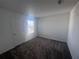 A spacious bedroom with neutral carpet, white walls, and a window providing natural light at 1796 Foreman Rd, Eagle Lake, FL 33839