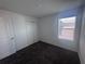 A carpeted bedroom with a window, closet, and neutral decor creates a cozy and inviting space at 1796 Foreman Rd, Eagle Lake, FL 33839