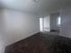 A carpeted room with windows, and access to additional rooms within the home at 1796 Foreman Rd, Eagle Lake, FL 33839