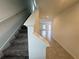 Bright foyer featuring a staircase with carpeted steps and leading to a spacious living area at 1796 Foreman Rd, Eagle Lake, FL 33839