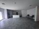Spacious living area leads into a kitchen with stainless steel appliances, a center island, and a view to the backyard at 1796 Foreman Rd, Eagle Lake, FL 33839