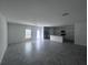 Open concept living and dining area with view into kitchen, stainless steel appliances and lots of natural light at 1796 Foreman Rd, Eagle Lake, FL 33839