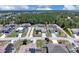 An aerial view of a residential neighborhood with single-Gathering homes, lawns, and mature trees at 199 Maple Dr, Kissimmee, FL 34759