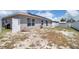 Large backyard featuring a white fence, solar panels, and plenty of open space at 199 Maple Dr, Kissimmee, FL 34759