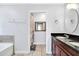 Bright bathroom featuring a double vanity with dark countertops, and an adjacent shower stall at 199 Maple Dr, Kissimmee, FL 34759