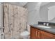 Well-lit bathroom featuring a vanity, toilet, and shower with an artistic curtain at 199 Maple Dr, Kissimmee, FL 34759