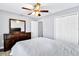 Cozy bedroom featuring a ceiling fan, dresser with mirror, and double closets at 199 Maple Dr, Kissimmee, FL 34759