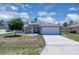 Single Gathering home featuring a two-car garage, neutral paint and front yard landscaping at 199 Maple Dr, Kissimmee, FL 34759