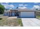 Charming single Gathering home featuring a two-car garage, neutral paint and manicured lawn at 199 Maple Dr, Kissimmee, FL 34759