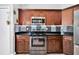 Modern kitchen with stainless steel appliances and dark wood cabinetry at 199 Maple Dr, Kissimmee, FL 34759