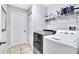 Functional laundry room featuring a washer, dryer, and shelving for supplies at 199 Maple Dr, Kissimmee, FL 34759