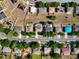 Overhead view of properties in neighborhood with street view and several backyards with pools at 1930 Knollcrest Dr, Clermont, FL 34711