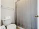 Cozy bathroom featuring toilet, towel rack, and shower with simple gray curtain at 1930 Knollcrest Dr, Clermont, FL 34711