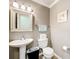 Half bathroom featuring a decorative mirror, pedestal sink, and neutral wall color at 1930 Knollcrest Dr, Clermont, FL 34711