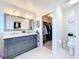 A modern bathroom features double sinks, a walk-in closet, and clean, bright decor at 1930 Knollcrest Dr, Clermont, FL 34711