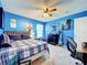 Comfortable bedroom features a desk, closet, and a ceiling fan at 1930 Knollcrest Dr, Clermont, FL 34711