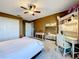 A cozy bedroom offers carpeted floors, a ceiling fan, and a bright, functional workspace at 1930 Knollcrest Dr, Clermont, FL 34711