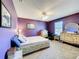 Cozy bedroom with purple walls and comfortable furnishings at 1930 Knollcrest Dr, Clermont, FL 34711